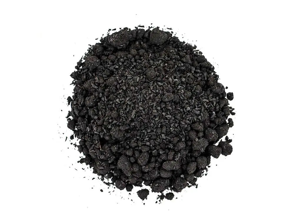 Turkish Storax incense, natural black resin powder in circular pile on white background for aromatherapy and meditation