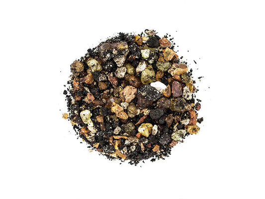 Pontifical incense blend of dark and golden resin granules in circular arrangement on white background