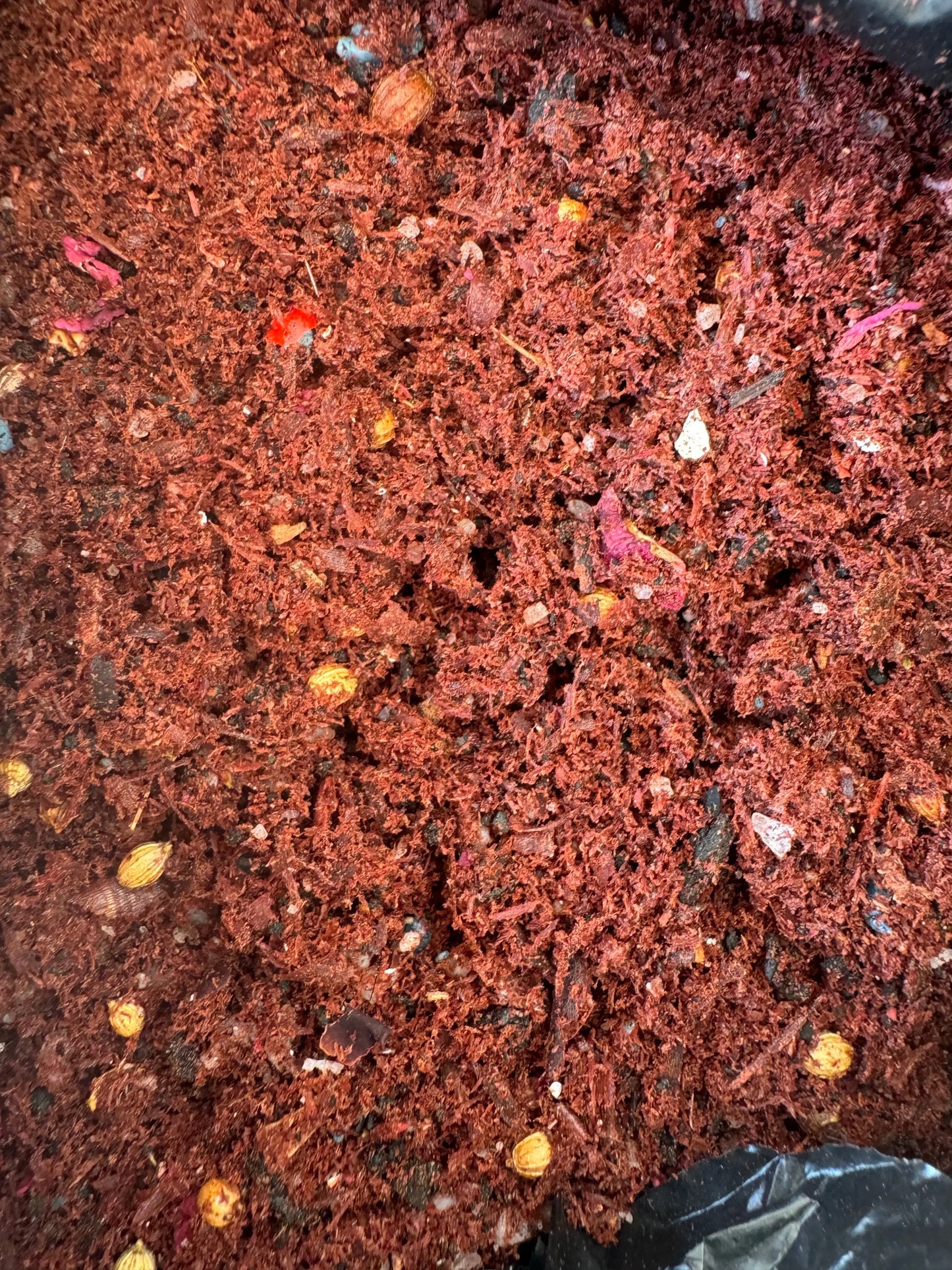 Egyptian Tfoussikha incense blend, reddish-brown granulated mixture with colorful resin fragments for spiritual cleansing and protection