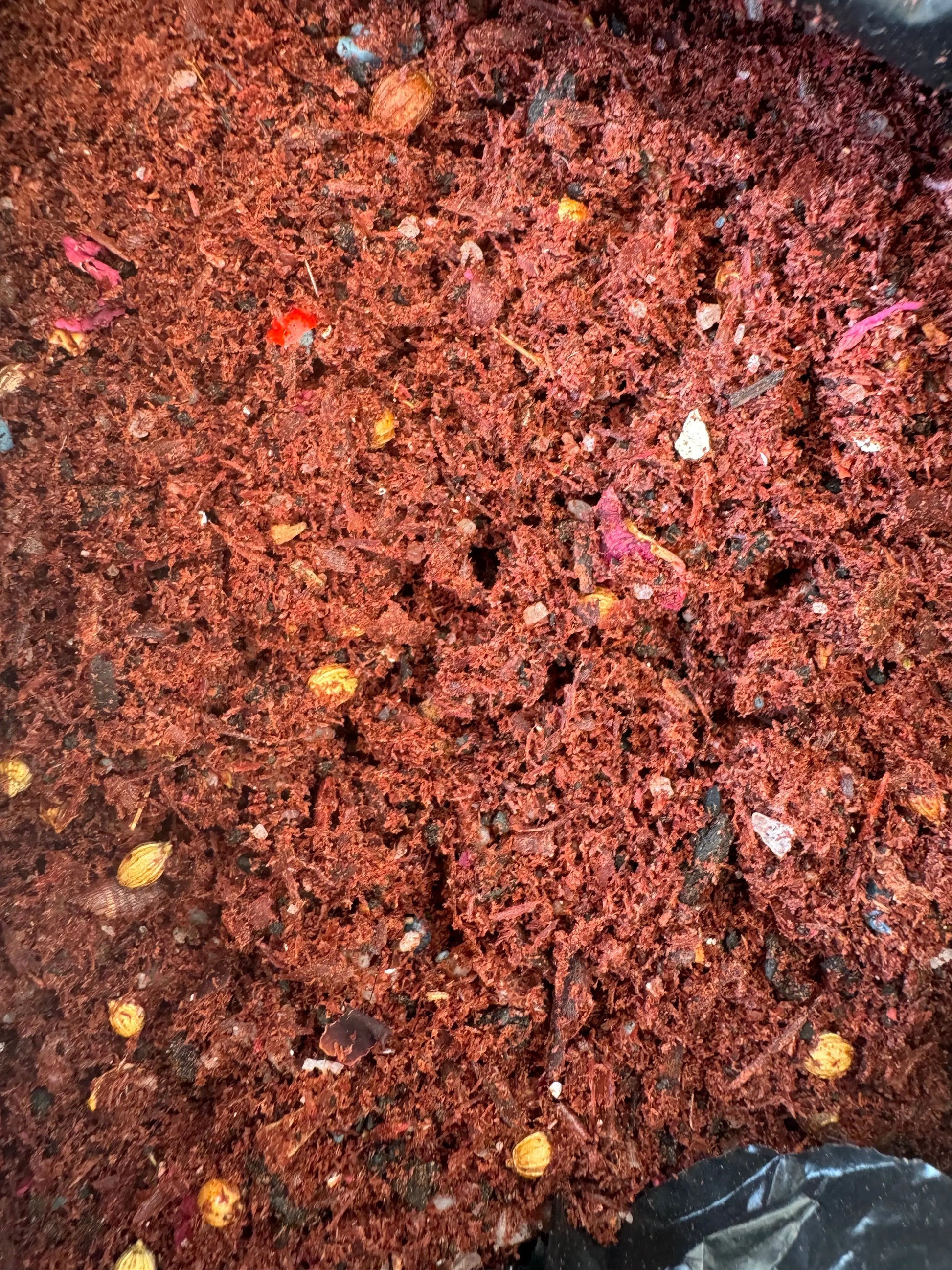 Egyptian Tfoussikha incense blend, reddish-brown granulated mixture with colorful resin fragments for spiritual cleansing and protection