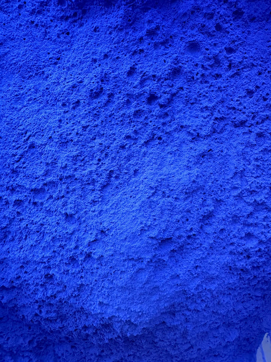 Zahra Zarqa natural laundry brightener powder in vibrant royal blue color texture close-up view