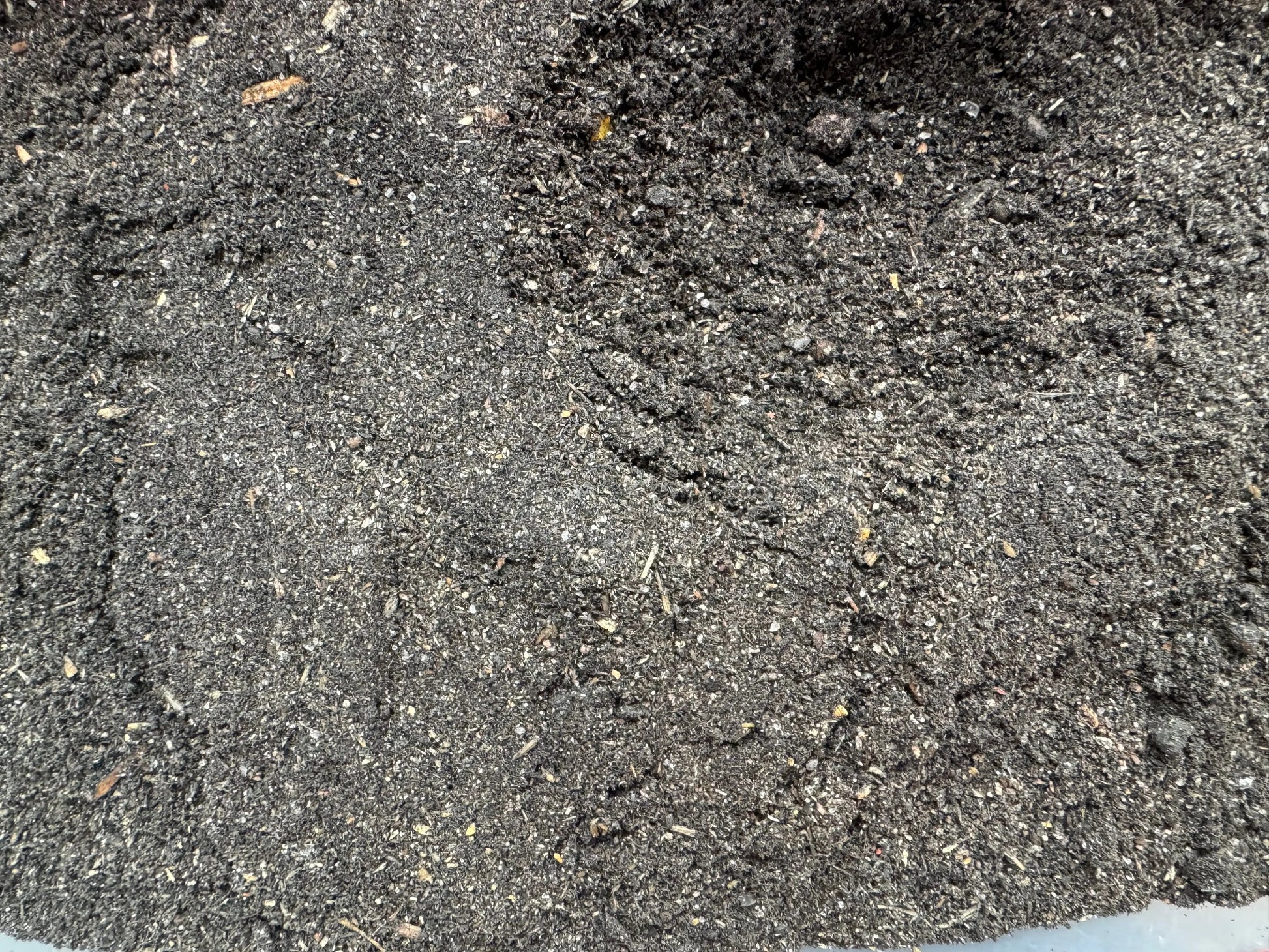 Egyptian musk incense blend shown as dark, finely ground aromatic powder with granular texture and mineral-like sheen