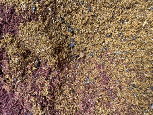 Egyptian Oud incense powder blend with golden brown and purple hues showing detailed granular texture