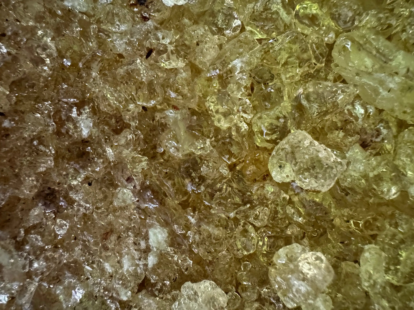 Egyptian Mastaka musk incense crystals in translucent amber and golden hues showing crystalline texture and natural resin formation