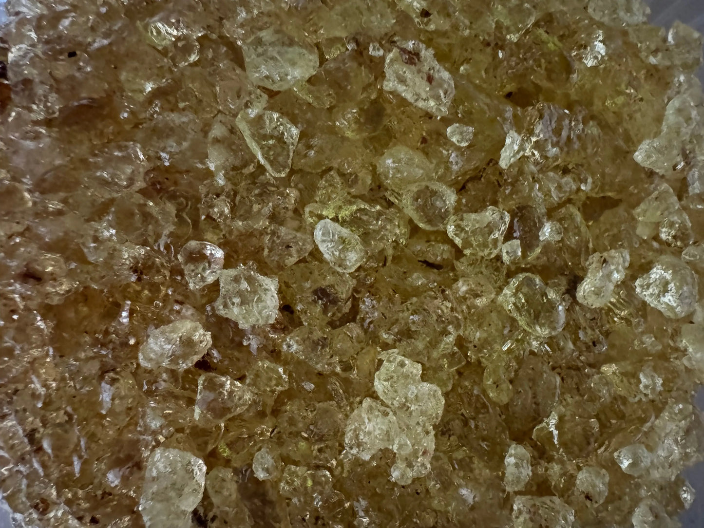 Close-up view of crystalline Mastaka oud incense resin from Egypt showing amber-colored granules with translucent texture