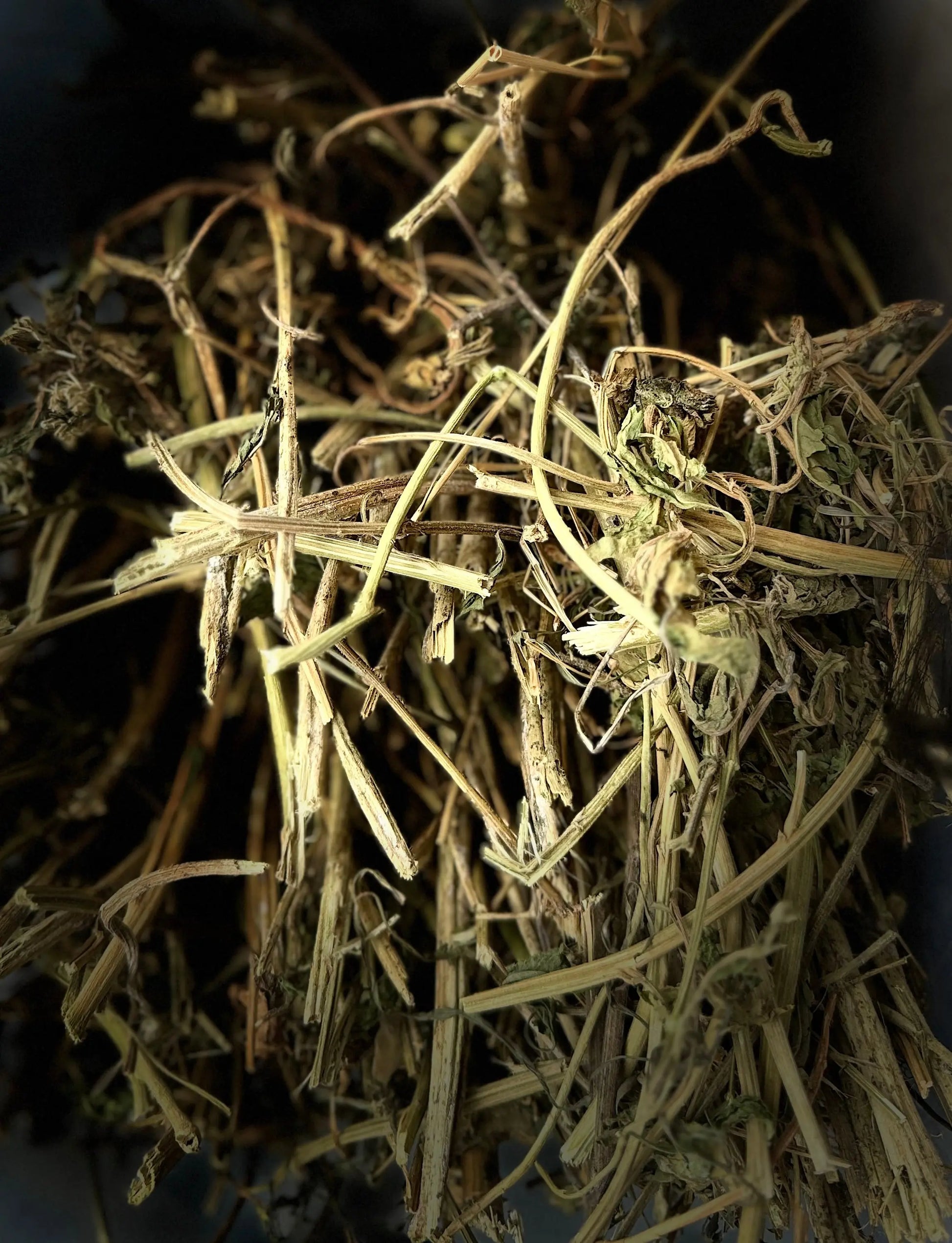 Dried Mkhinza (mkhenza) medicinal herb stems and leaves closeup showing natural texture and golden-brown color