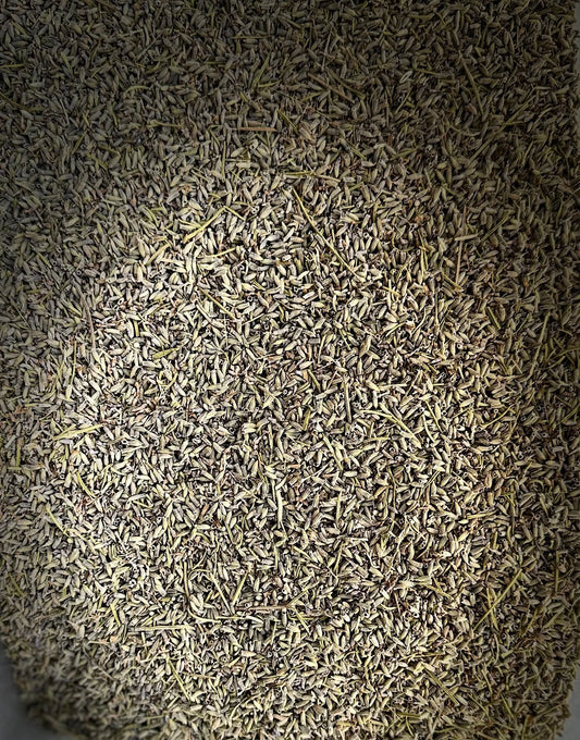 Dried Khouzama lavender herbs in grey-green color, scattered densely across frame with natural vignette lighting effect