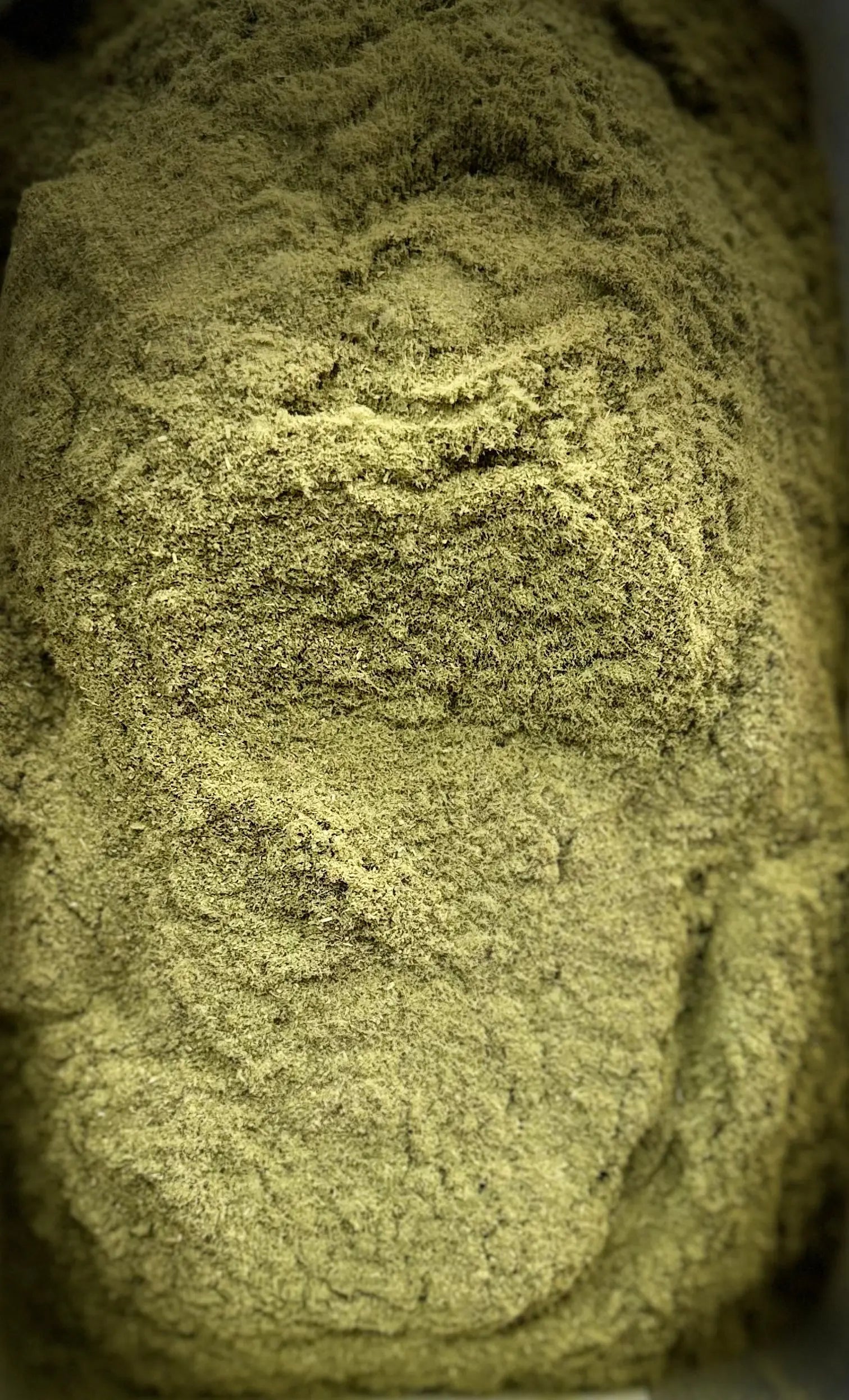 Close-up texture of El zaz herb powder showing fine, olive-green granules with natural layered pattern for 30g package