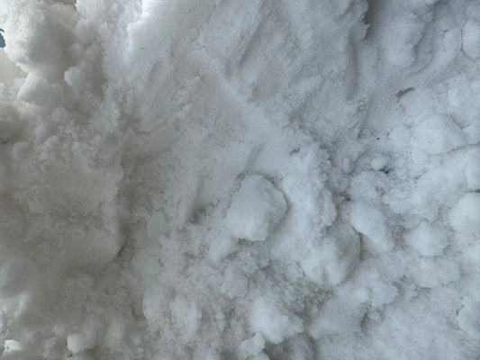 Close-up view of raw Alum stone chunks (Pierre d'alun) showing crystalline white mineral texture and natural formations