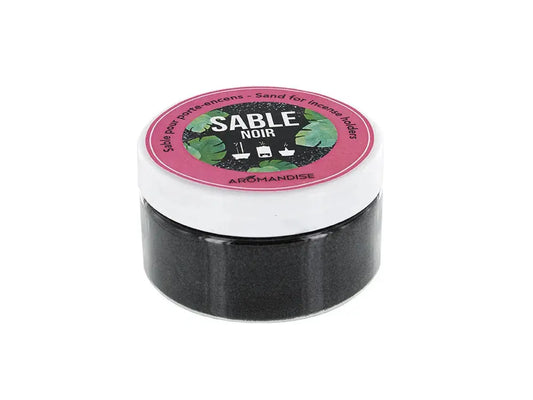 Black incense sand Sable Noir in round container with pink lid, showing 100g of fine dark sand for incense holders