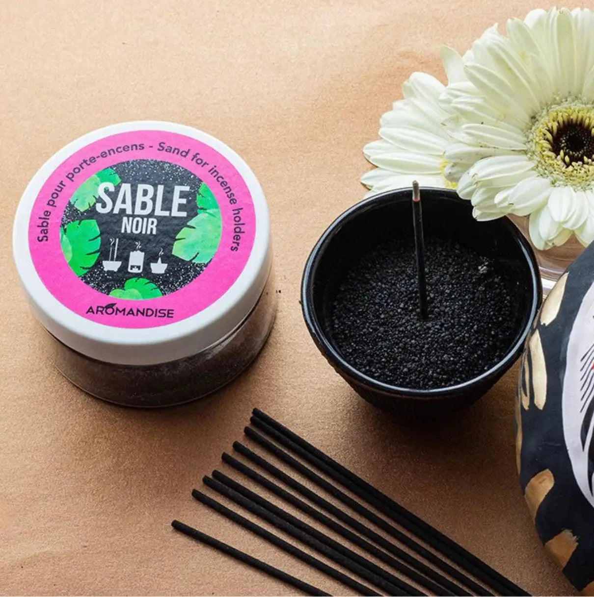 Black sand for incense burner Sable Noir 100g shown with product container, black sand sample and incense sticks