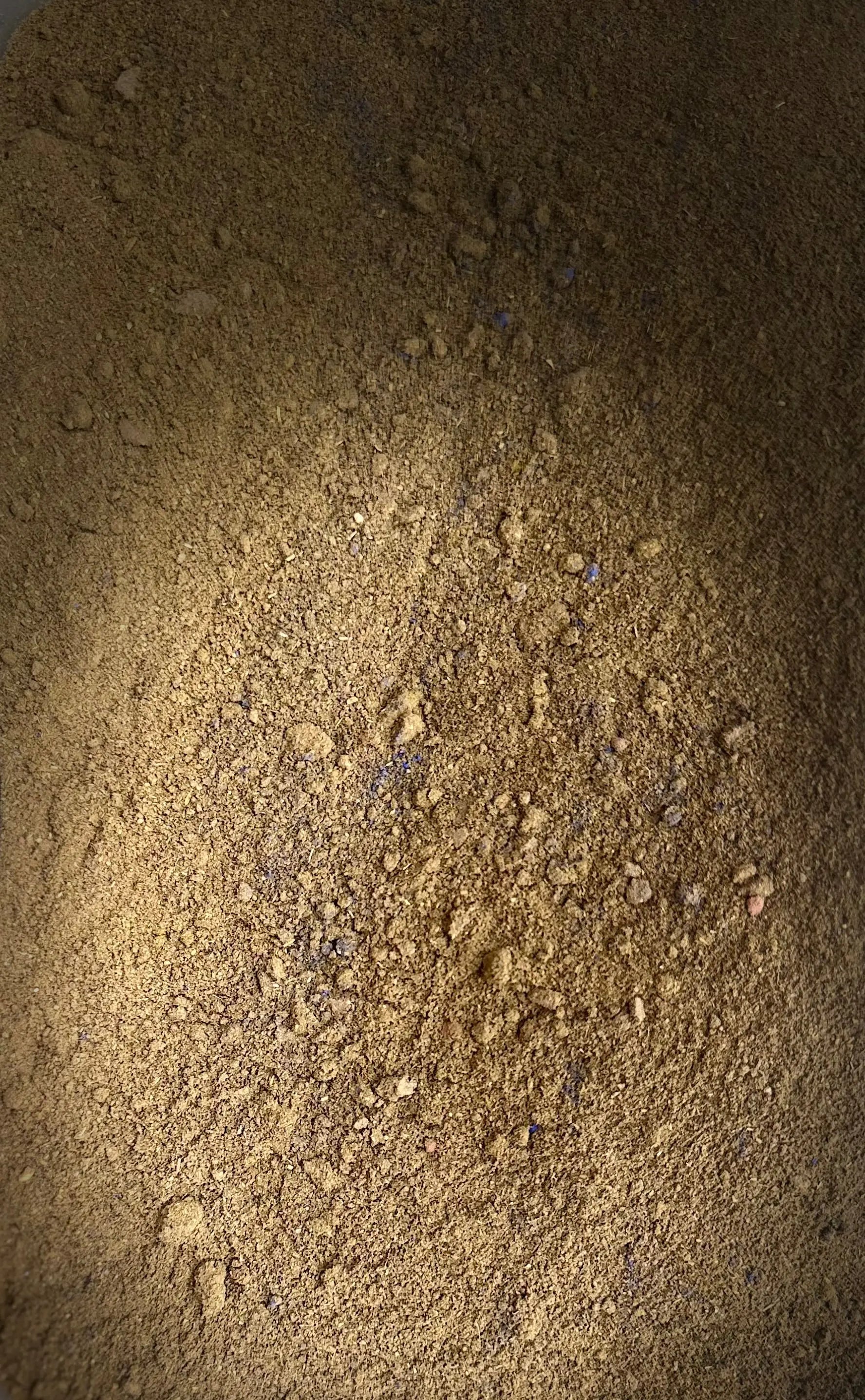 Tebrima traditional Moroccan herbal body powder blend with fine golden-brown texture and natural ingredients