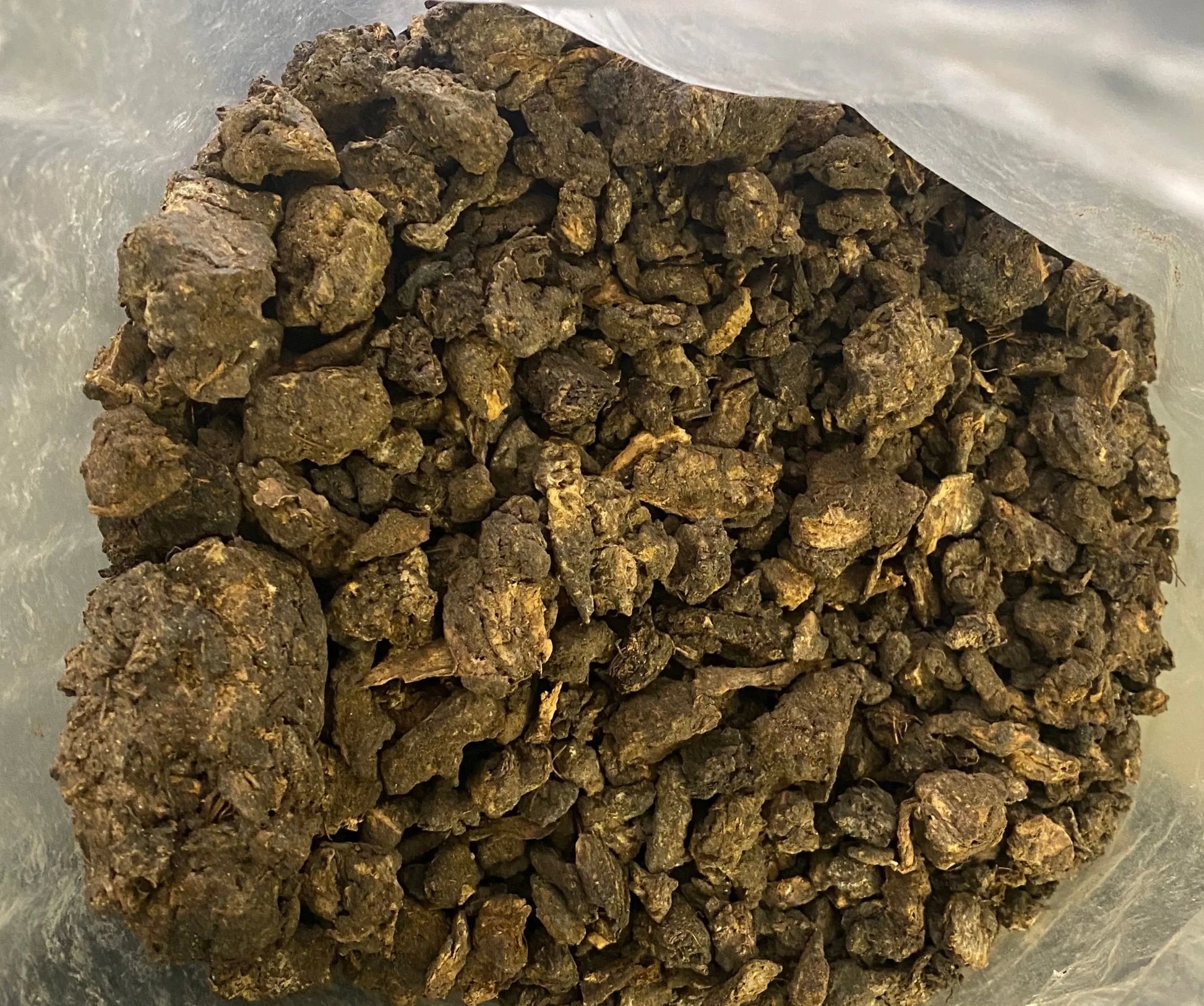 Black Fassoukh incense resin chunks in plastic bag, traditional Maghrebi purification and protection incense
