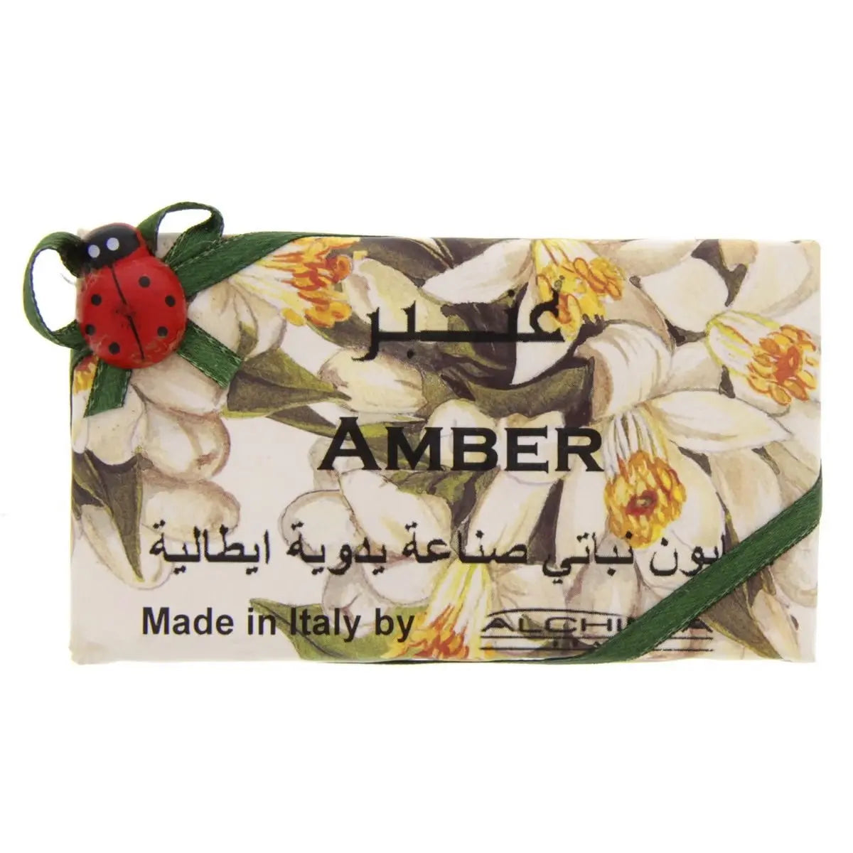 Alchimia Amber Vegetal Soap bar with floral design, decorative ladybug charm, and Arabic text on white packaging