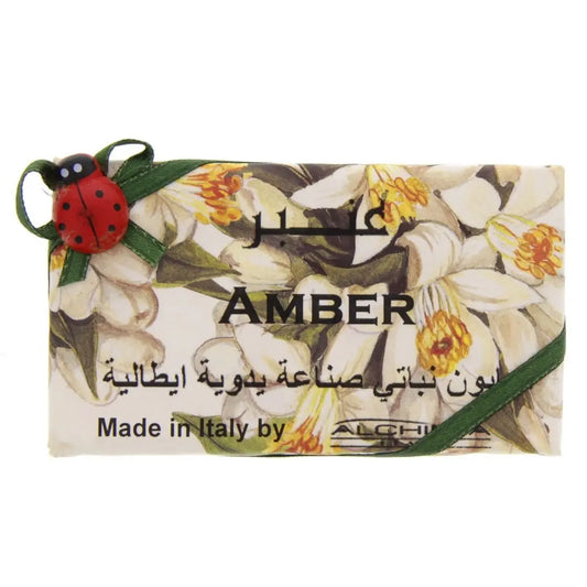 Alchimia Amber Vegetal Soap bar with floral design, decorative ladybug charm, and Arabic text on white packaging