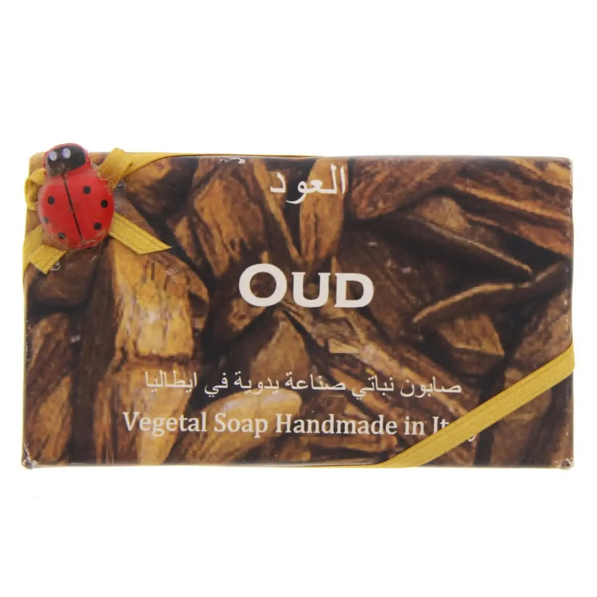 Alchimia Oud Vegetal Soap bar with brown wooden texture design and decorative ladybug ornament on yellow ribbon accent