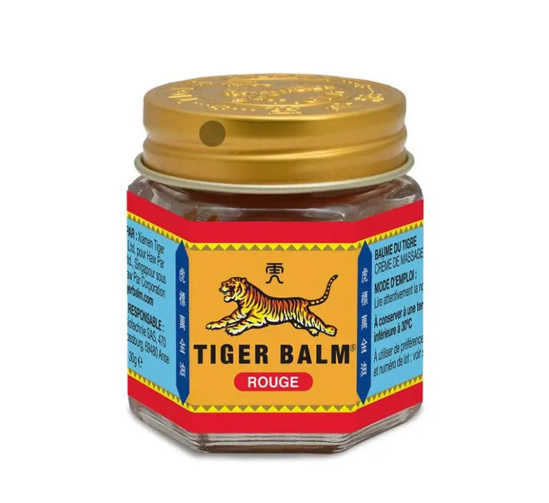 Tiger Balm Red ointment jar showing traditional packaging with tiger logo and gold cap on hexagonal glass container
