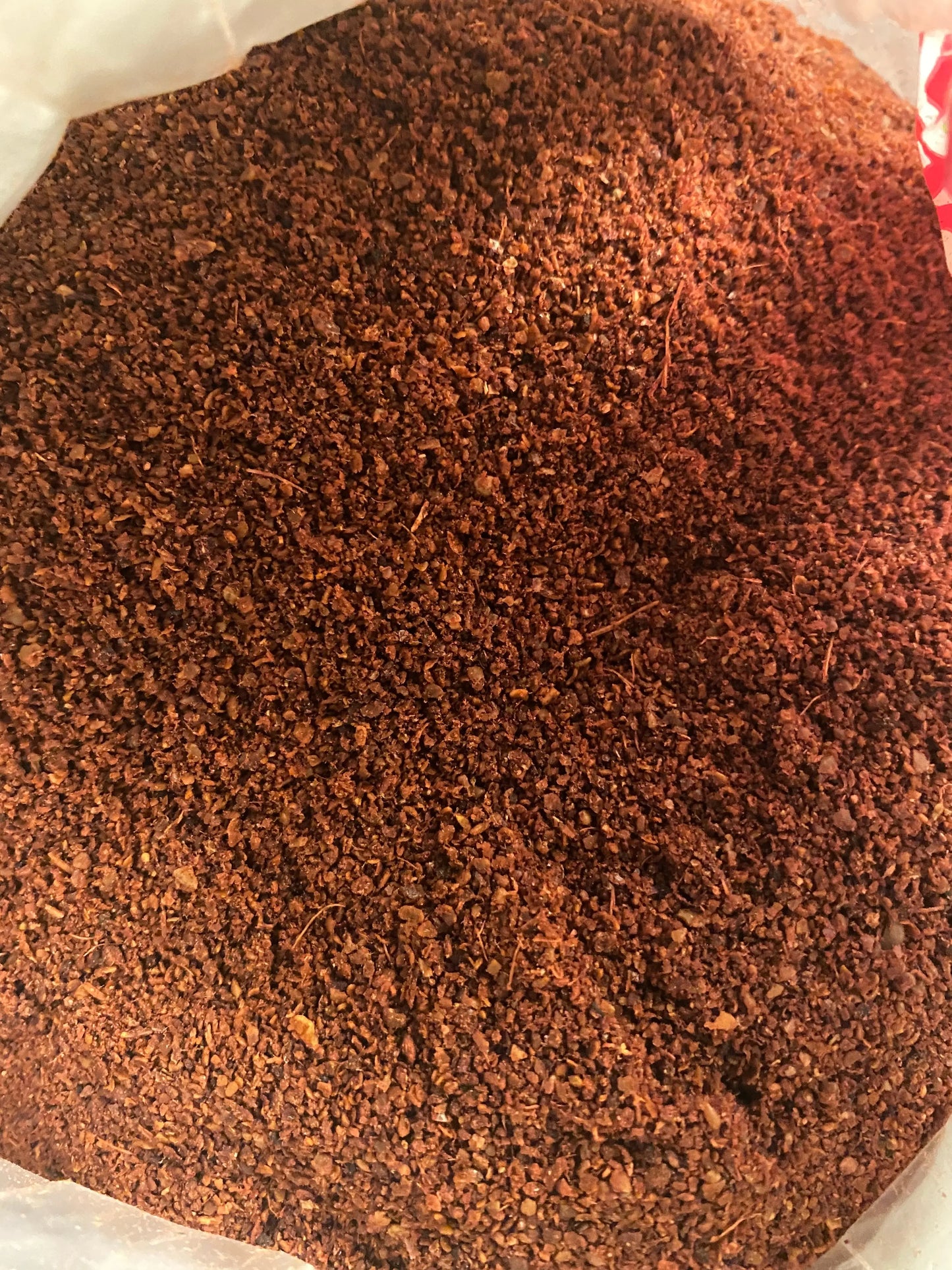 Ground sumac spice powder in deep burgundy red color showing fine granular texture of Middle Eastern seasoning