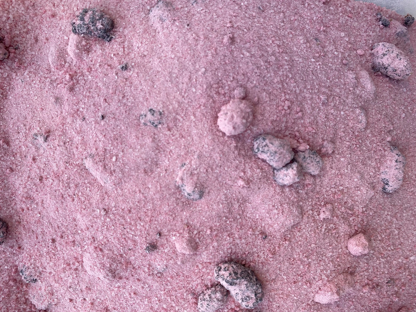 Turkish blackberry tea powder blend with dried berry pieces scattered across pink granulated sugar mixture