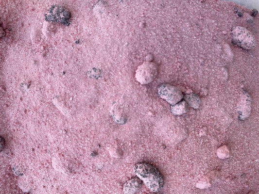 Turkish blackberry tea powder blend with dried berry pieces scattered across pink granulated sugar mixture