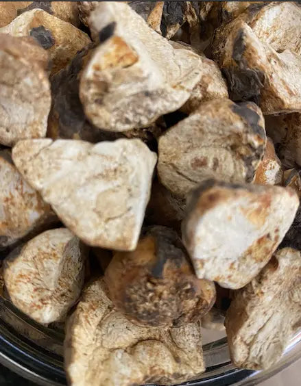 Close-up view of Bakbouka (bekbukkah) dried rock crystals, showing natural beige and brown chunks in varying sizes with rough, irregular surfaces, displayed in a clear container. Traditional Middle Eastern spice known as talghouda or talrouda, 100g quantity.