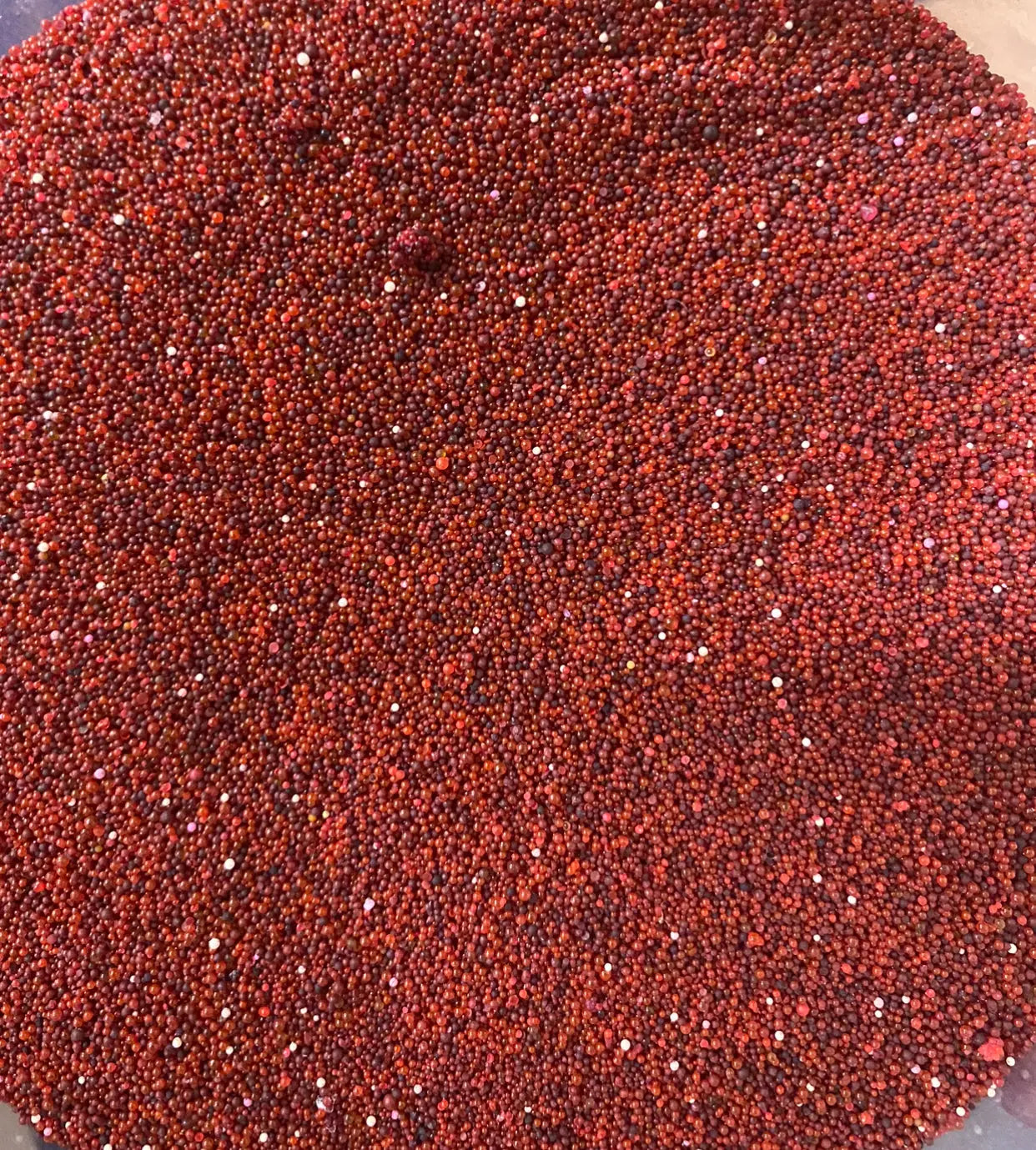 Close-up view of el r3ida rida rehida red granules showing uniform texture and vibrant color of traditional Middle Eastern spice