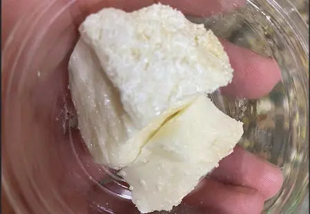Raw white chunks of Louban Lybie frankincense resin in clear glass container showing crystalline texture