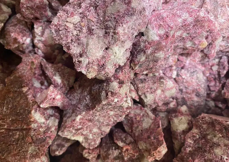 Red Benjoin Djaoui incense chunks in crystalline form, showing natural pink and reddish mineral textures